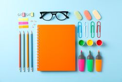 Flat lay composition with school supplies on color background, space for text