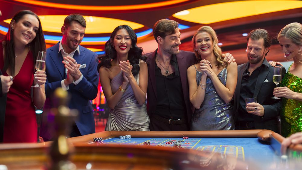 Casino Enthusiasts Making Calculated Bets at a Roulette Table.