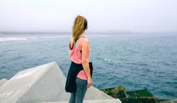 Unrecognizable young woman watching the sea