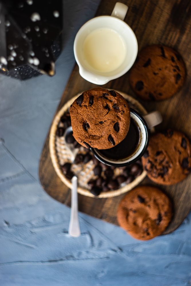 Top view of coffee surrounded by cookies