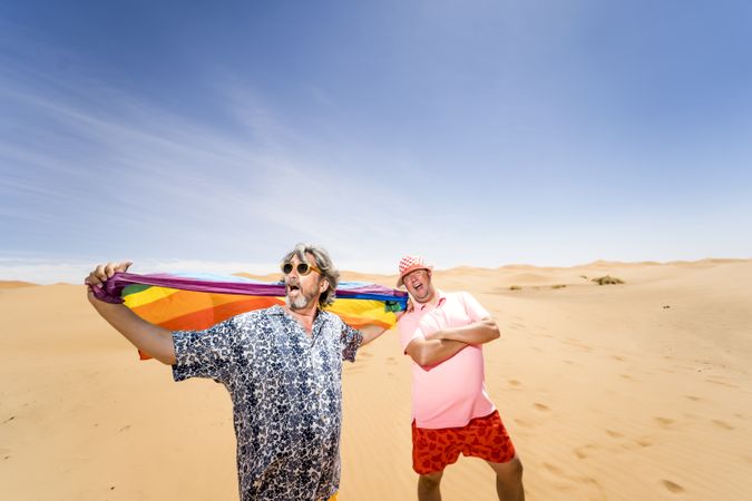 Excited gay couple in desert