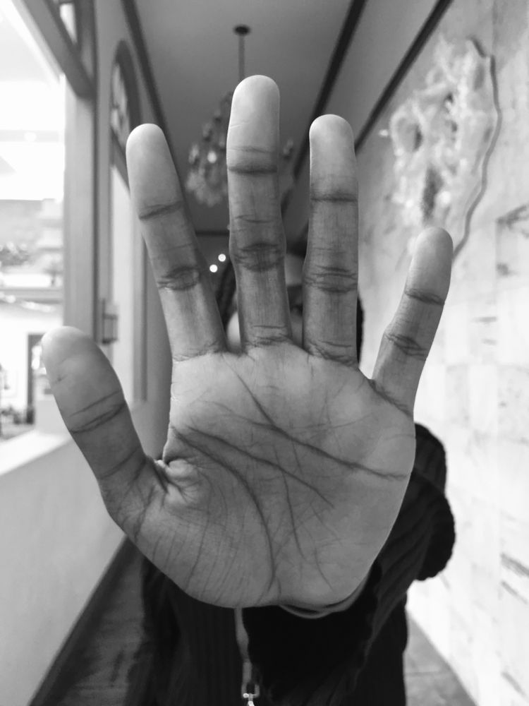 Grayscale photo of man's hand