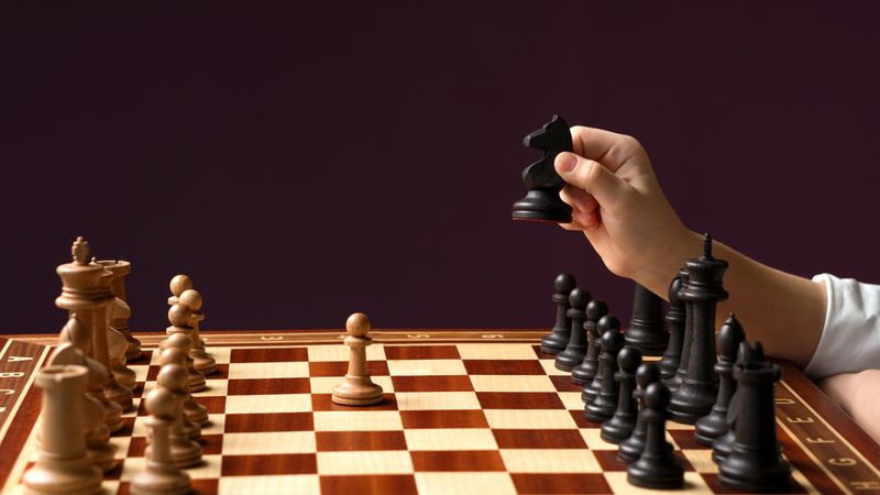 Hand with chess piece