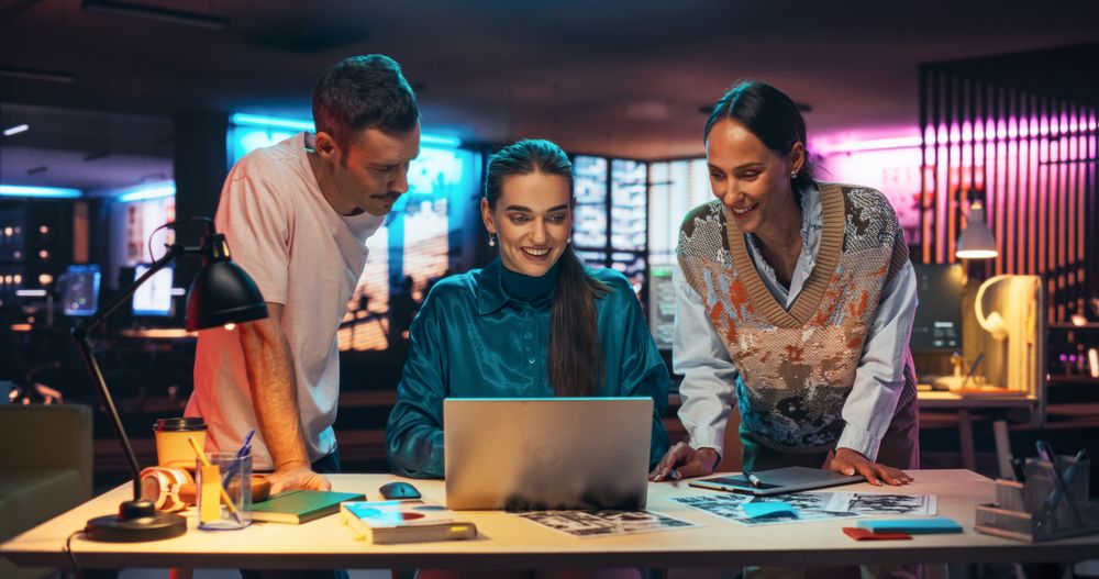 Group of Young Successful Businesspeople Making a Team Meeting in Creative Agency Using Laptop Computer.