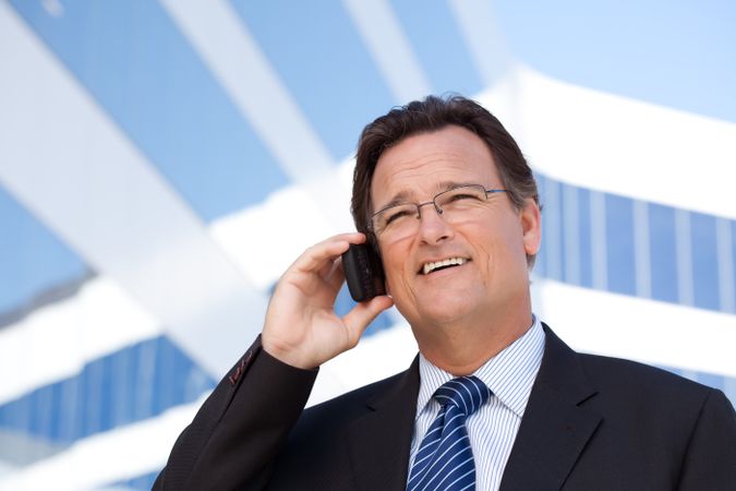 Businessman Smiles as He Talks on His Cell Phone