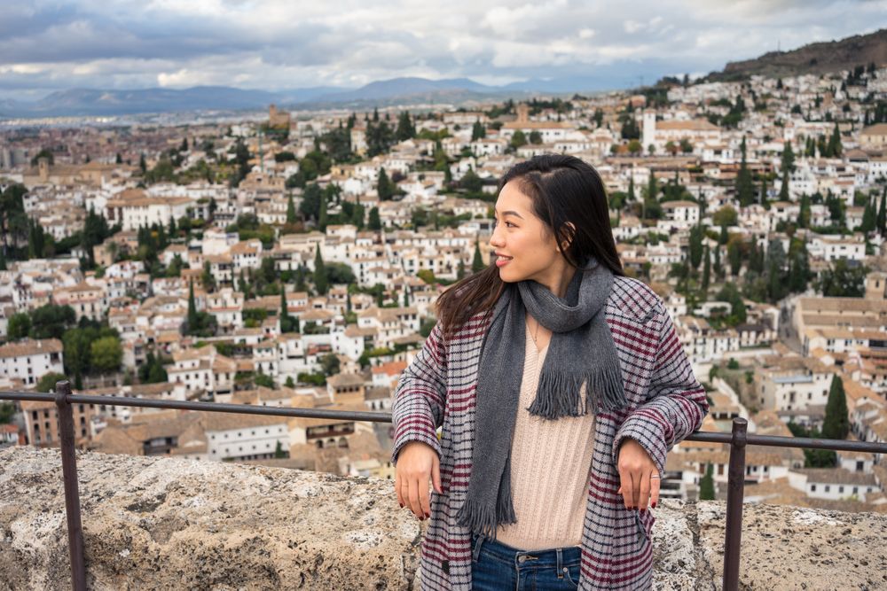 Cheerful woman visiting ancient city