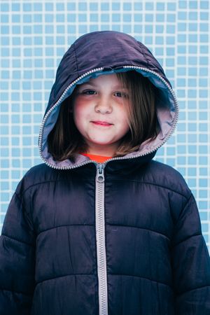 Girl in warm clothes standing in empty pool