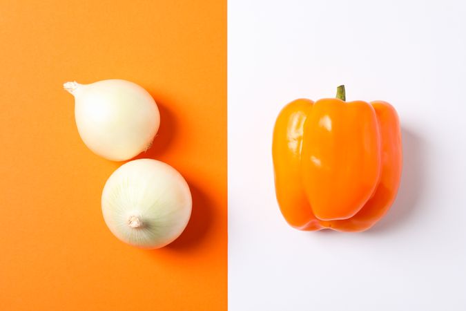 Onion and pepper on two tone background, space for text