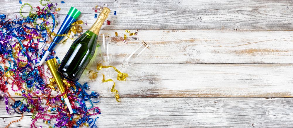 New Year party decorations and champagne on rustic wood