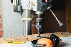 Modern drilling machine in grunge carpentry