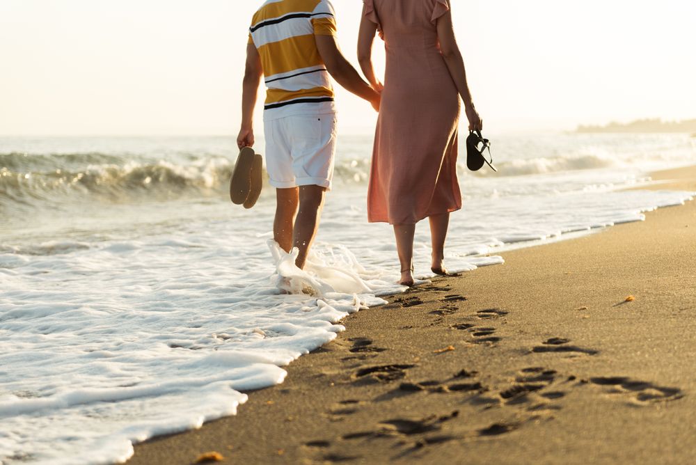 Adult couple walking towards sea