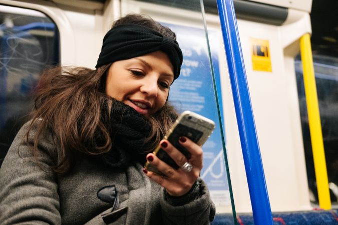 Woman using smartphone in train