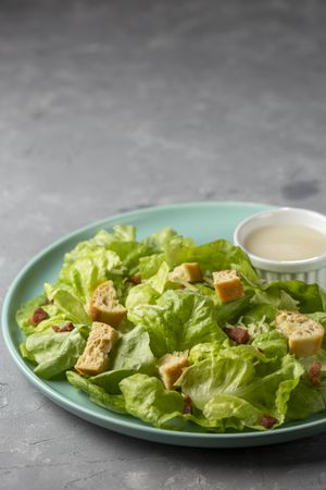 Caesar salad with croutons and bacon.
