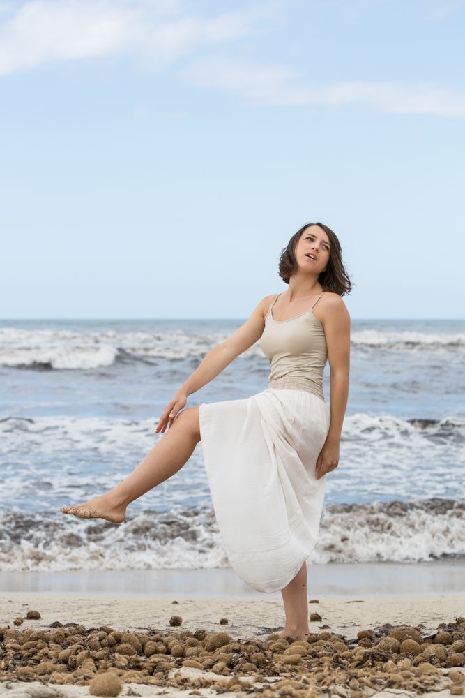 Charming young woman on shore near water