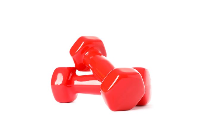 Red dumbbells for fitness isolated on plain background