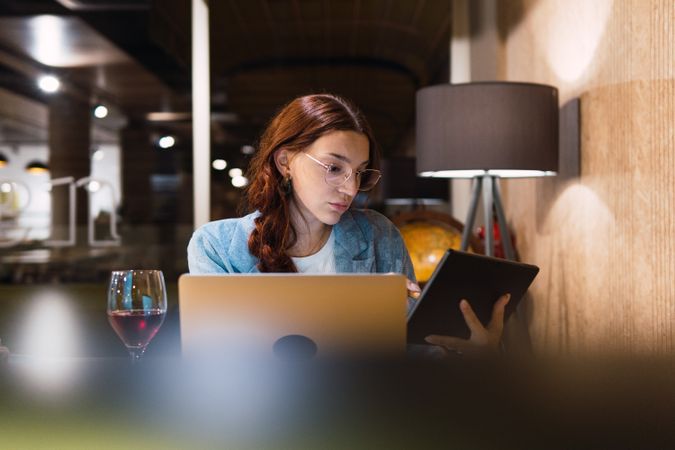 Young businesswoman using tablet in restaurant