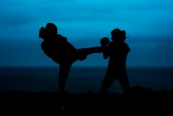 Anonymous kickboxers fighting at night