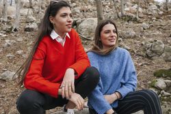 Smiling women in sweaters in park