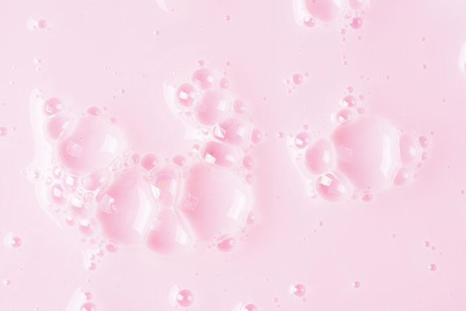 Soap bubbles on pink backdrop, minimal