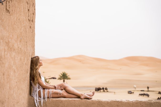 Woman on terrace against desert landscape