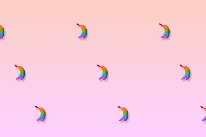 Multi-colored bananas on gradient pink and purple background