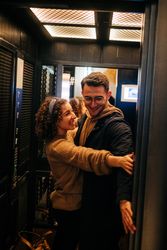 Happy couple standing in elevator