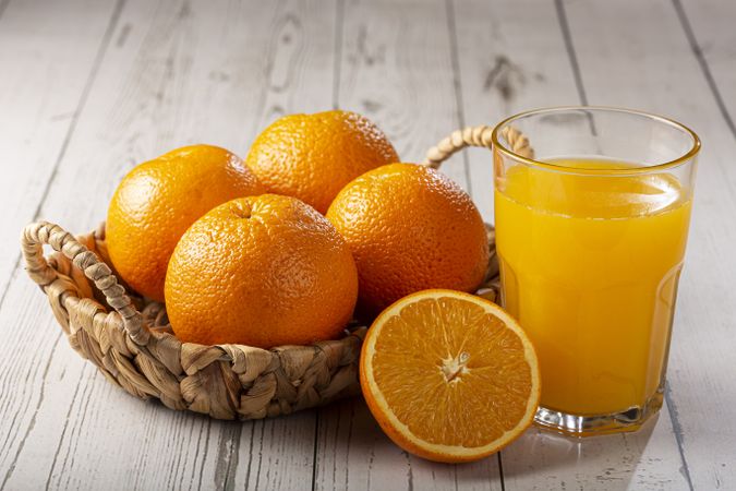 Glass with orange juice on the table.