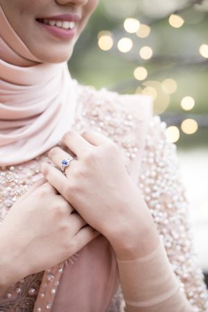 Woman wearing pink hijab and sapphire ring