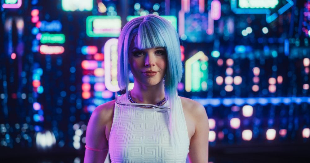 Portrait of a Cyberpunk Cosplay Gamer with Blue Hair Looking at Camera with a Happy Smile.