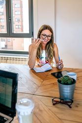 Office worker talking mobile phone with speaker