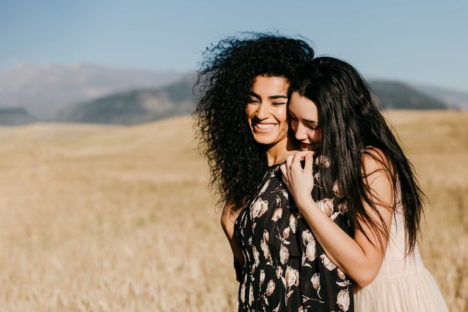 Female friends standing in field
