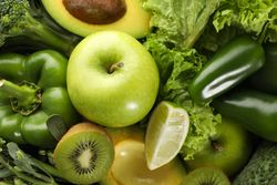 Green vegetables and fruits on whole background