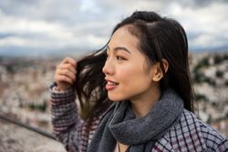 Cheerful woman visiting ancient city