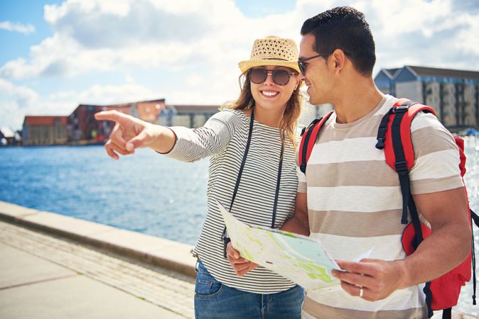 Woman pointing and man holding map