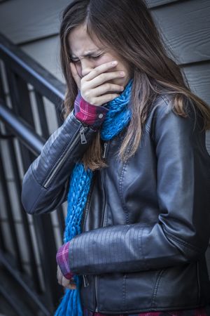 Young Crying Teenaged Girl on Staircase