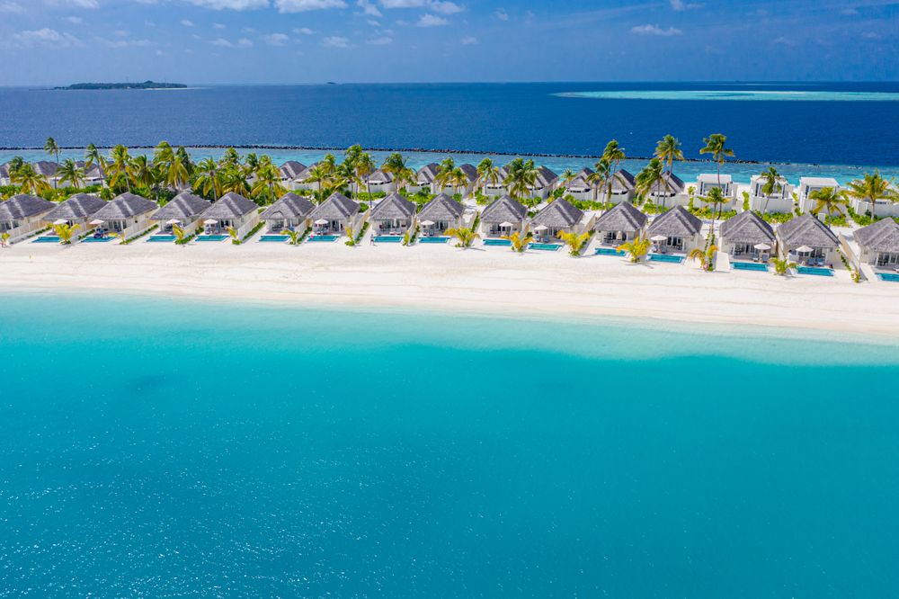 Rows of holiday villas in a tropical beach resort with copy space