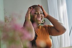 Positive Black woman putting on hijab