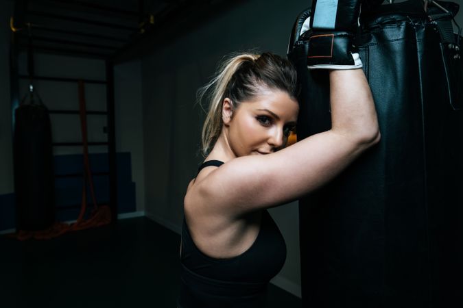 Woman training in gym with punching bag