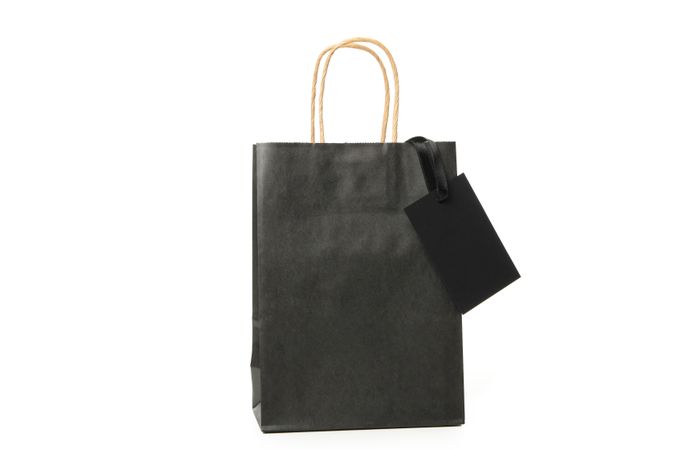 Paper bag with tag isolated on blank background
