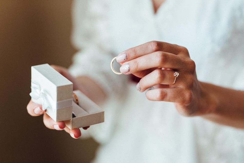 Woman holding a box with golden rings