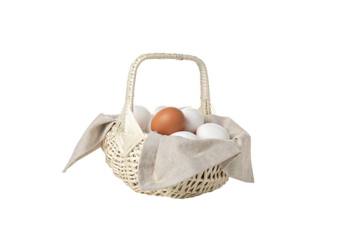 eggs in a wicker basket with handles, isolated on blank background.
