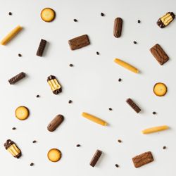 Cookies and coffee bean pattern on light background