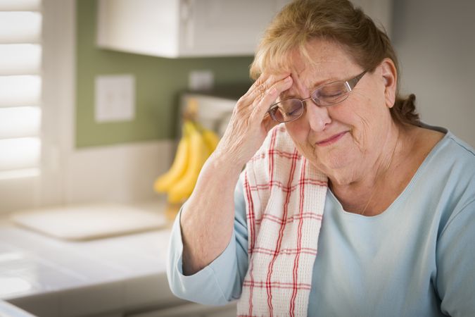 Sad Crying Older Adult Woman At Kitchen Sink