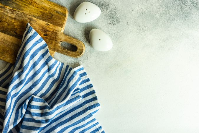 Modern salt and pepper shaker with wooden spoons on kitchen counter with copy space