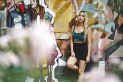 blonde model leaning on street wall