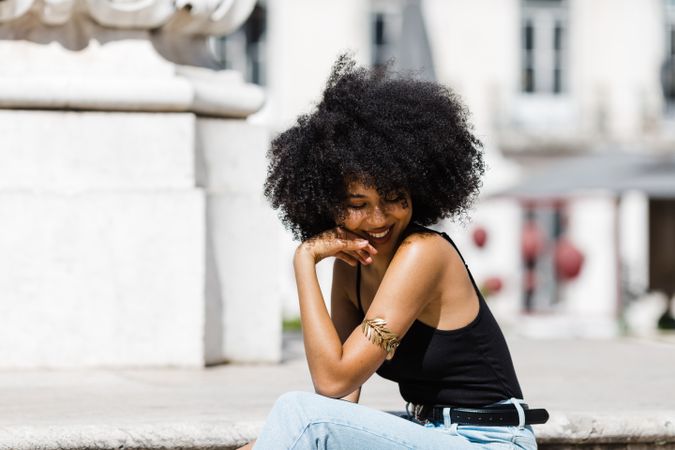 Black female siting on stairs outdoors
