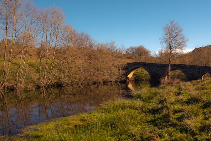 Old bridge over calm river