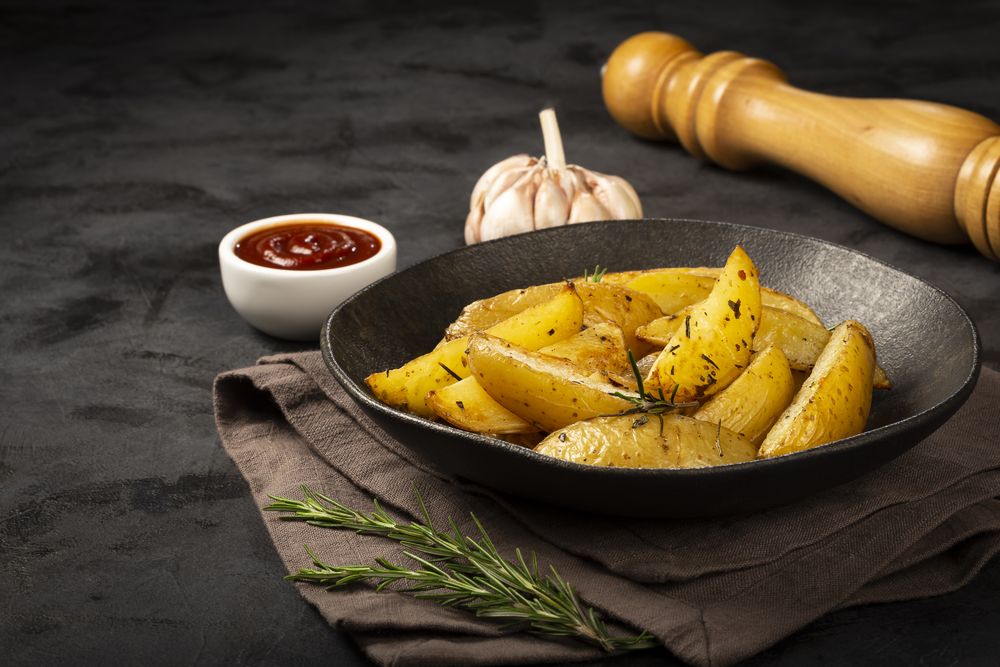 Roasted potatoes with rosemary on the plate.