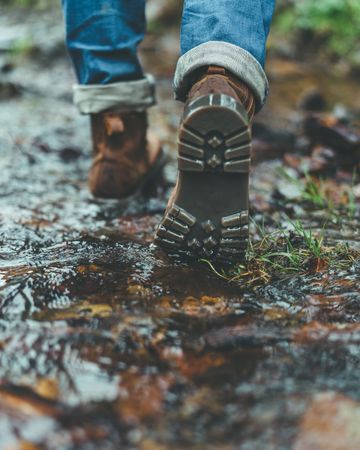 Man walking on wet autumn trail