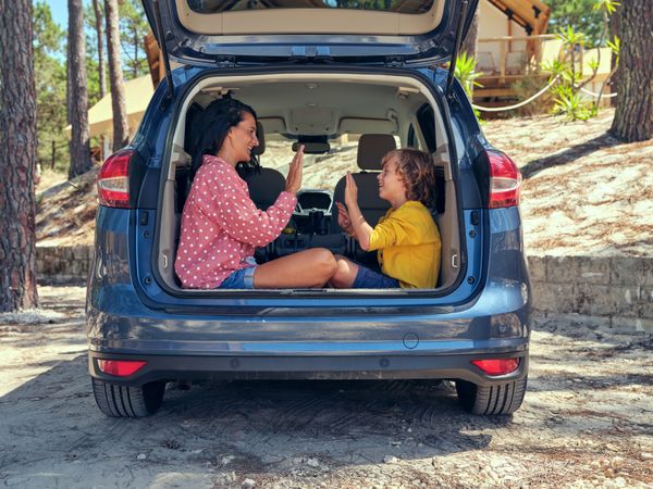 Mother with son playing in car truck